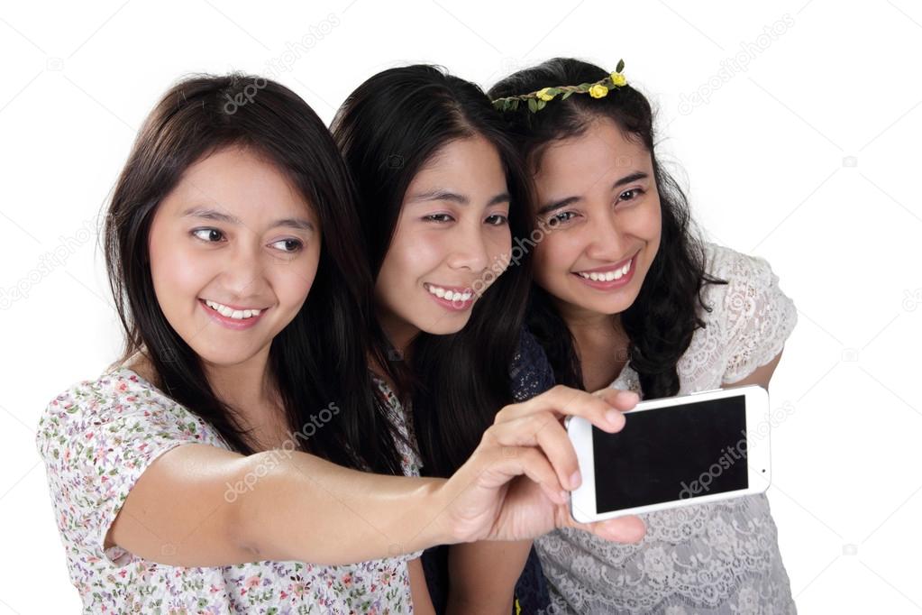 Cheerful girls take selfie