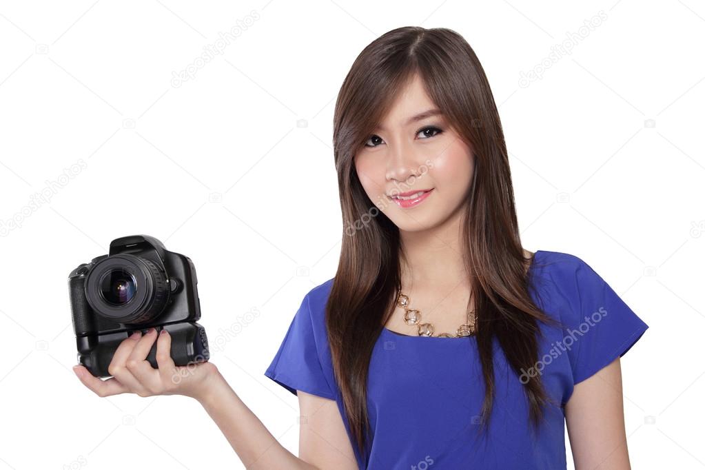Smiling Asian girl holding camera.
