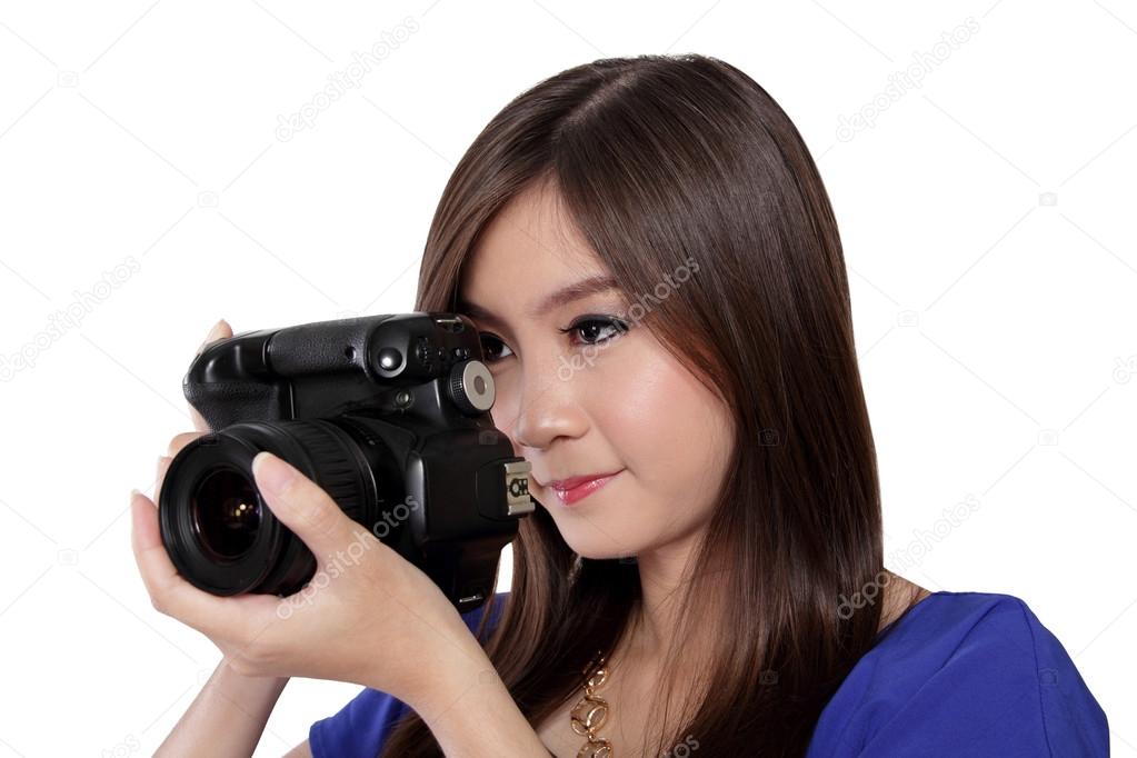 Asian girl focusing to take a picture