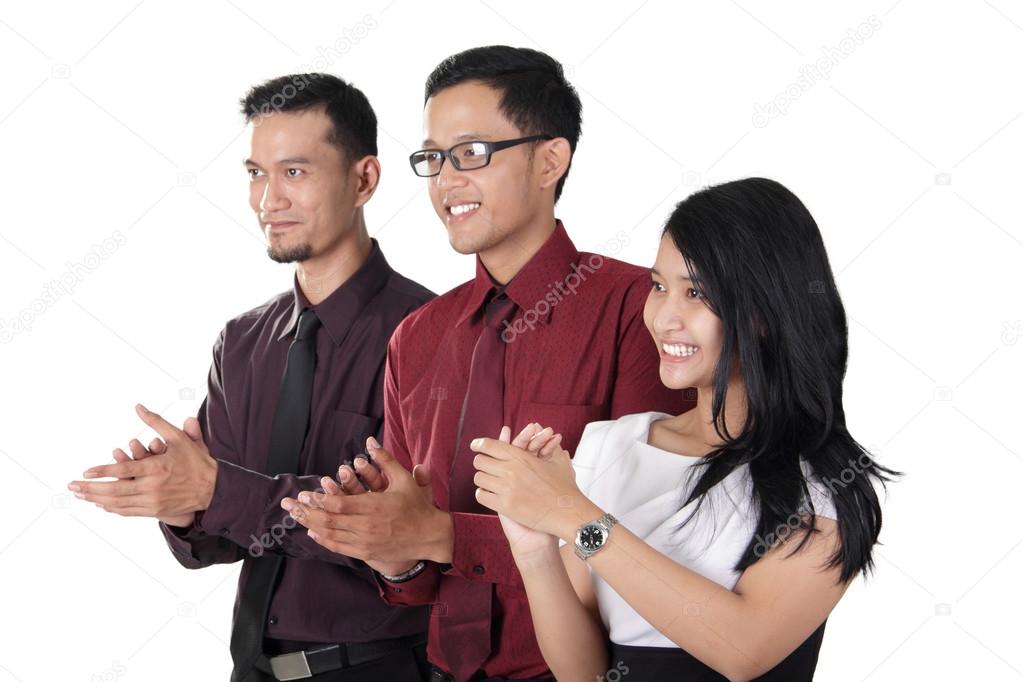 Asian business team clapping hands