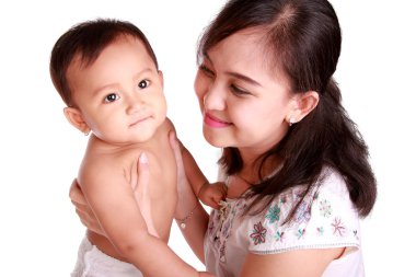 Bebek ve sevgi dolu annesi gülümseyerek