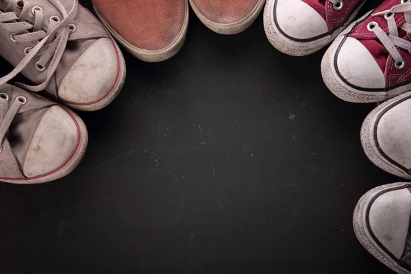 Dirty sneakers in circle for copy space — Stock Photo, Image