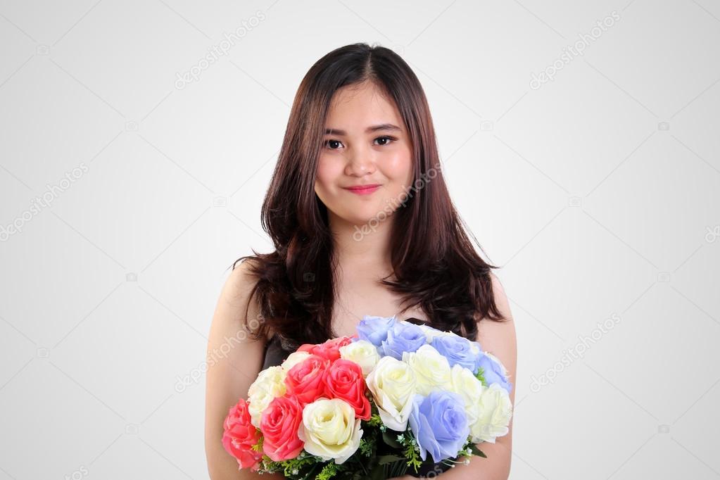 Cute innocent girl with colorful roses 