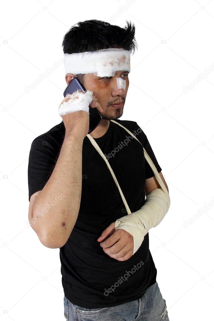 Accident victim talking on mobile phone isolated