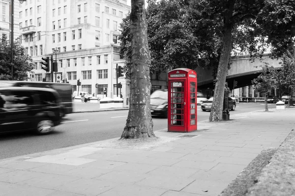 A single red telephone box on the street, BW — Stock Photo, Image