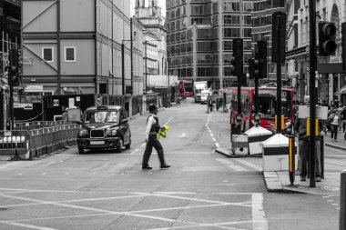 Police officer crossing street, London, England