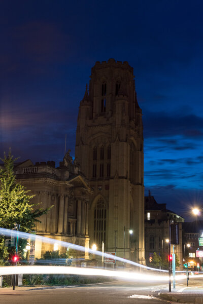 ENGLAND, BRISTOL - 13 SEP 2015: Fascade of WIlls Memorial Building by night, view with Bristol Museum and motion blur car lights