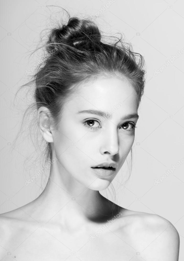 Glamour portrait of beautiful woman model with fresh daily makeup and funny wavy hairstyle.