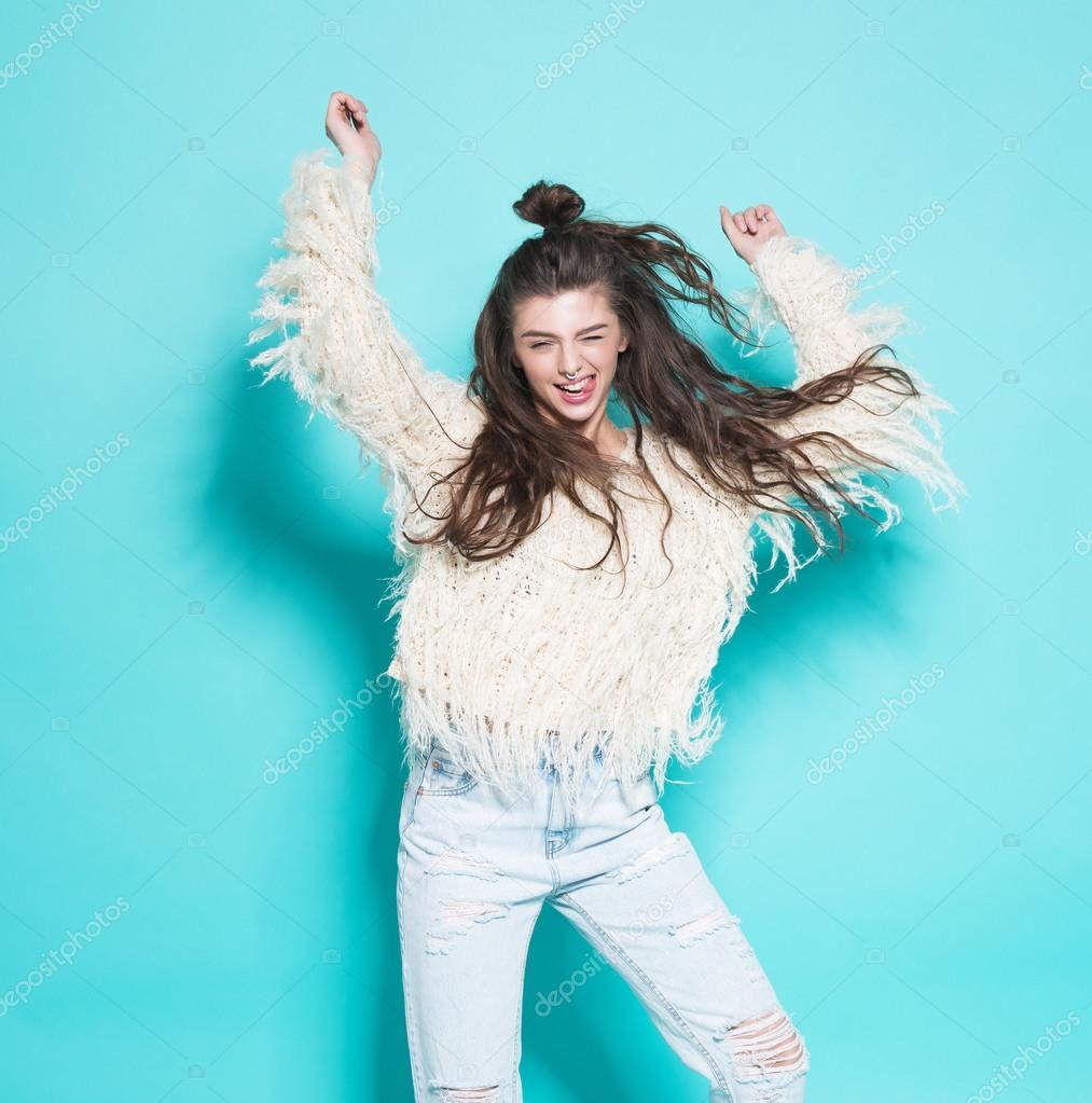 Portrait of cheerful fashion hipster girl going crazy making funny face and dancing. Blue color background. Stock Photo by ©Rattleray 71086493 Portrait of cheerful fashion hipster girl going crazy making funny face and dancing. Blue color background. Stock Photo by ©Rattleray 71086493