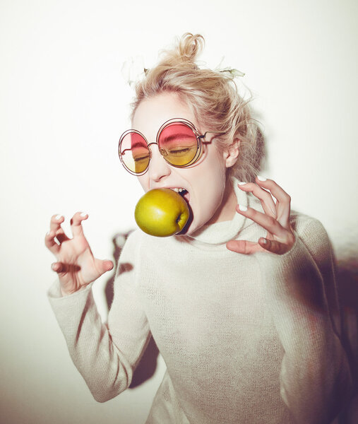 blond woman with green apple holding apple hipster version  bible Eva
