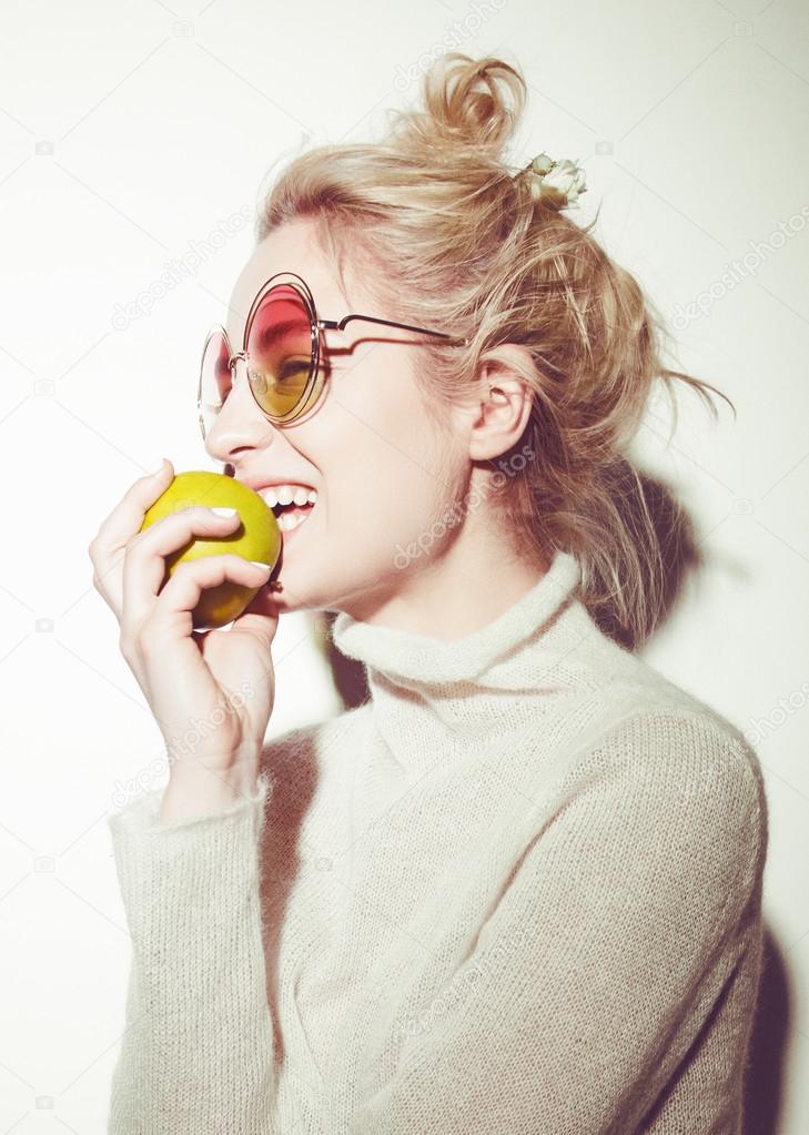 blond woman with green apple holding apple hipster version  bible Eva