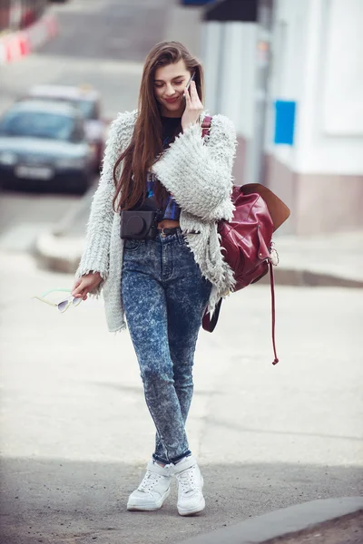 Fashion women tourist keep digital compact camera and look photo on screen. Hipster  style sunglasses and coat. Outdoor portrait Stock Photo by ©Rattleray  71906951