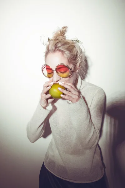 blond woman with green apple holding apple hipster version  bible Eva