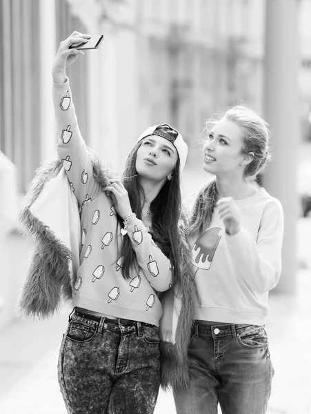 Novias Hipster tomando una selfie en el contexto urbano de la ciudad - Concepto de amistad y diversión con nuevas tendencias y tecnología - Mejores amigos eternizando el momento con un teléfono inteligente moderno — Foto de Stock