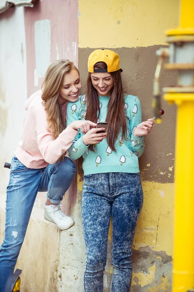 two girlfriends are hugging and having fun