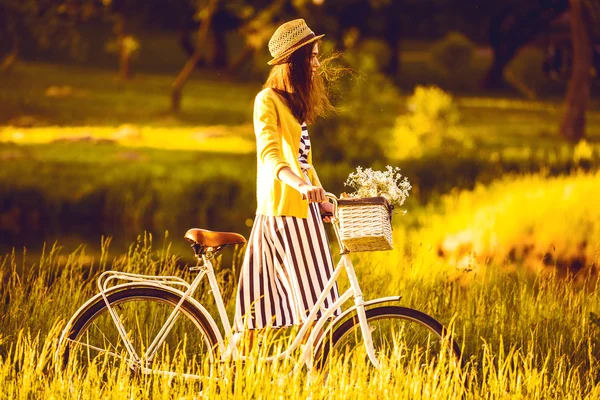 Girl on a bike in the village — Stock Photo, Image