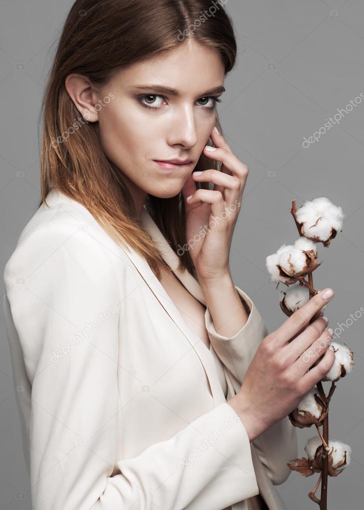 fashion model woman with cotton plant balls in her hands 