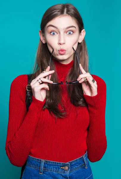 Retrato de chica de moda en un suéter rojo elegante y gafas de sol sobre un fondo blanco. Estilo urbano — Foto de Stock