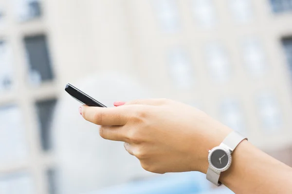 Frau hält Smartphone in der Hand — Stockfoto