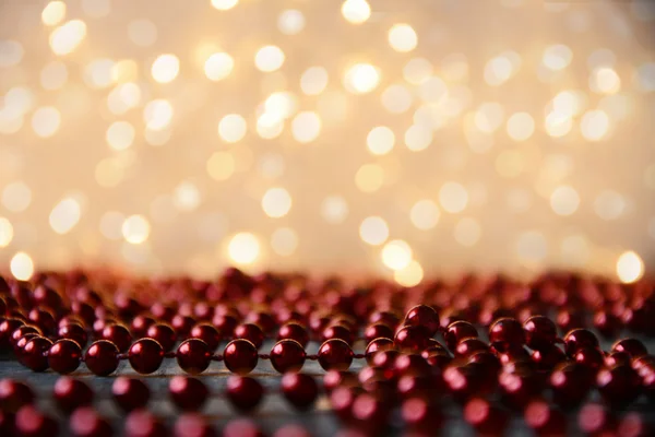 Red decorating pearls with lights blur effect — Stock Photo, Image