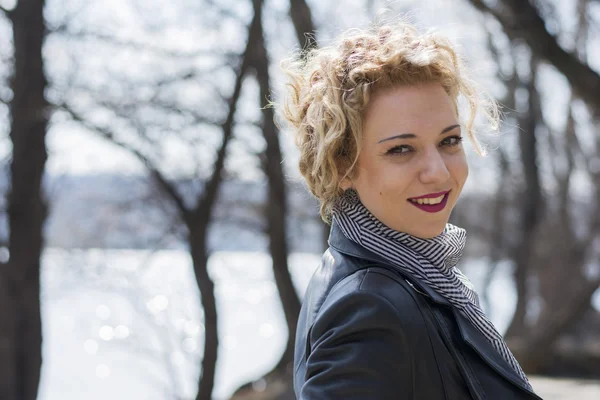 Young curly blond woman smiling — Stock Photo, Image