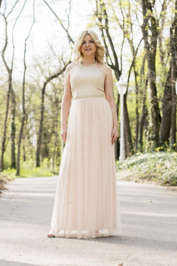 Blond woman in evening gown posing