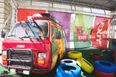 Colorful retro minivan of EXIT festival 2015 in city center of N clipart