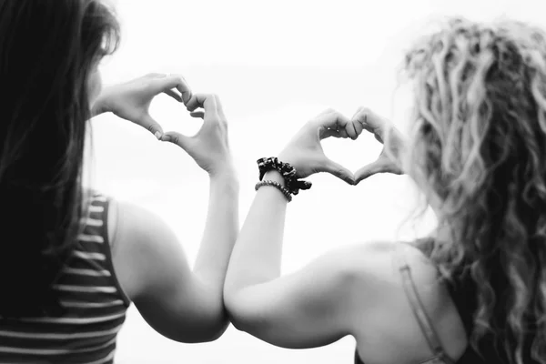 Duas meninas fazendo forma de coração — Fotografia de Stock