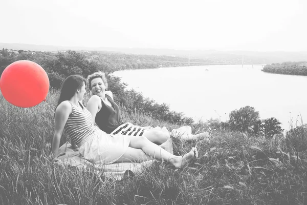 Two best girl friends sitting on the grass — Stock Fotó