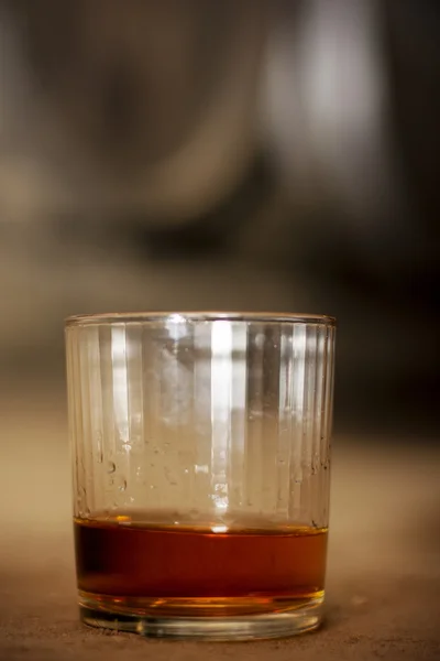 Glass of whiskey in distillery — Stock Photo, Image