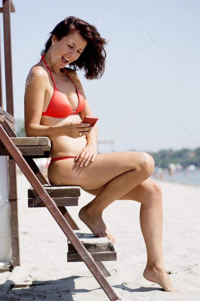 Woman on the beach in red bikini