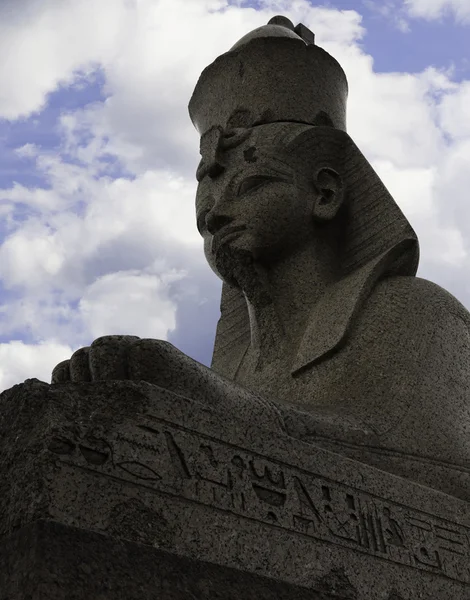 Authentic antique Egyptian sphynx on quay of the Neva river against cloudy sky