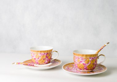 iki vintage bardak, sauceres ve beyaz zemin üzerine kaşık