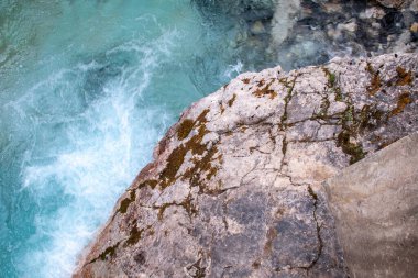 Johnston Canyon, Banff, Alberta, Kanada - Ağustos 2020: Ön planda yosunlu gri bir kaya (Rocky Dağları) ile turkuaz bir su girdabı). 