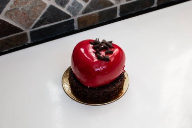 A heart-shaped, cherry-red champagne and berry chocolate miniature cake made for Valentine's Day 2021, Ontario, Canada. 
