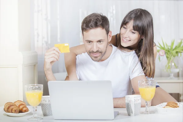 . Glada leende par använder kreditkort för att Internet Shop on-line. — Stockfoto