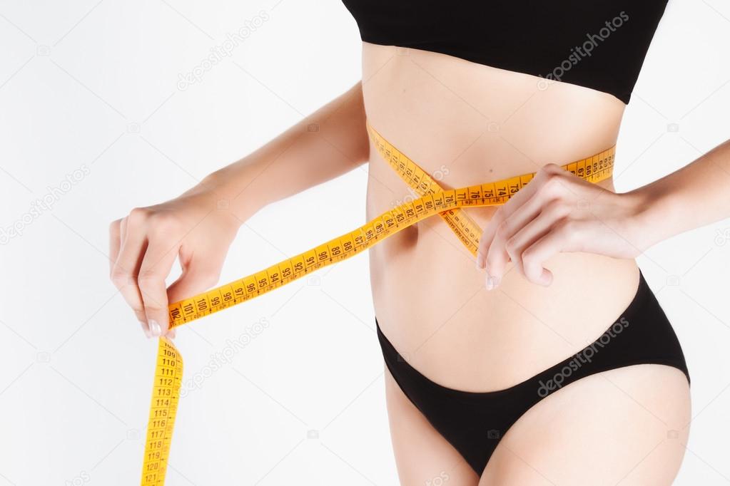Slim woman with measure tape