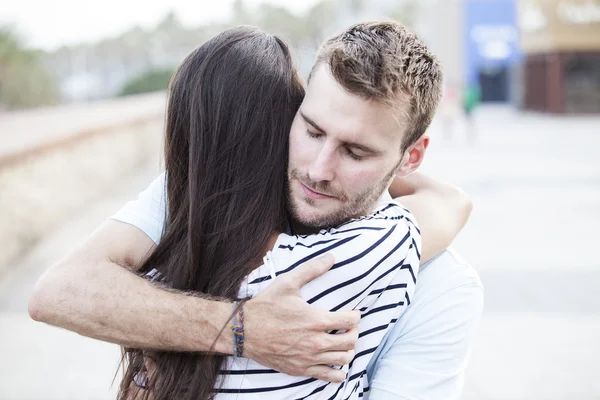 Happy teen couple embracing at street — Stock Photo, Image