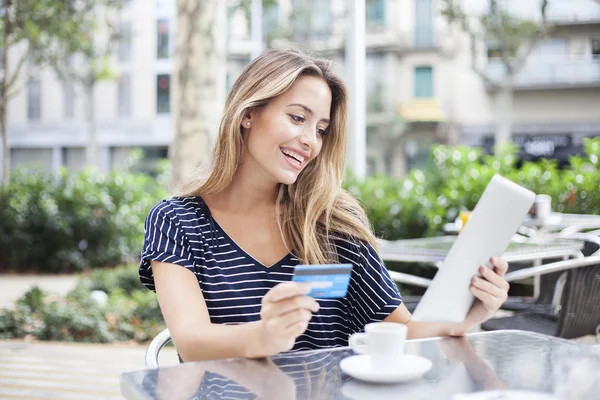 Mujer comprando en línea con una tableta y una tarjeta de crédito — Foto de Stock