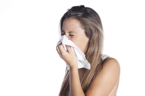 Sick young woman blowing her nose — Stock Photo, Image