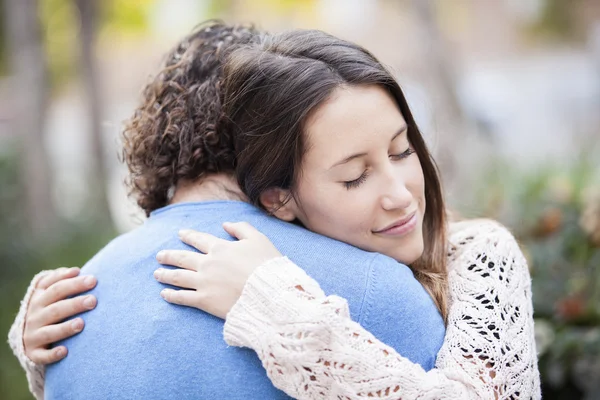 Lovely young couple hugging in a park — Stock Photo, Image