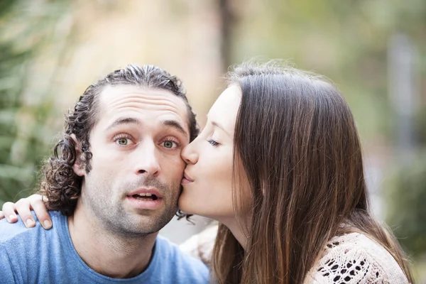Pretty woman kissing man on the cheek — Stock Photo, Image