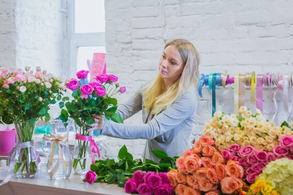 Professional floral artist working with flowers at studio