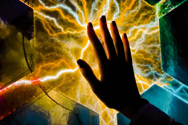 Woman hand touching plasma panel display in dark room of museum - close up view — Stock Photo, Image