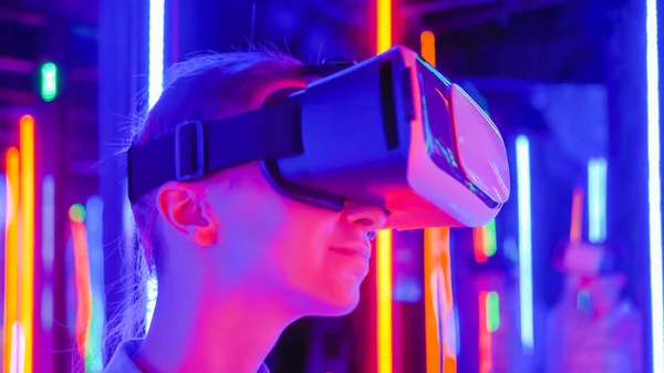 Woman using virtual reality headset at interactive VR exhibition: close up