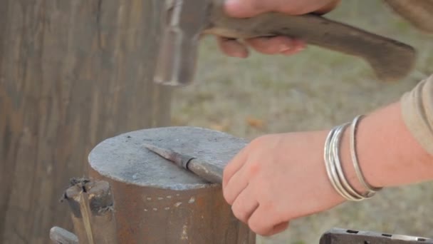 Blacksmith working with spearhead on anvil outdoor - slow motion, close up — 비디오