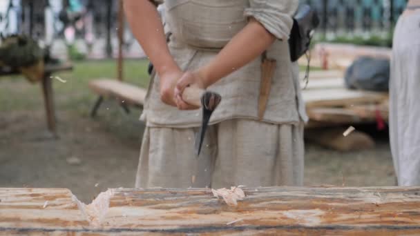 Man houthakker snijden grote log met bijl op medival festival - slow motion — Stockvideo