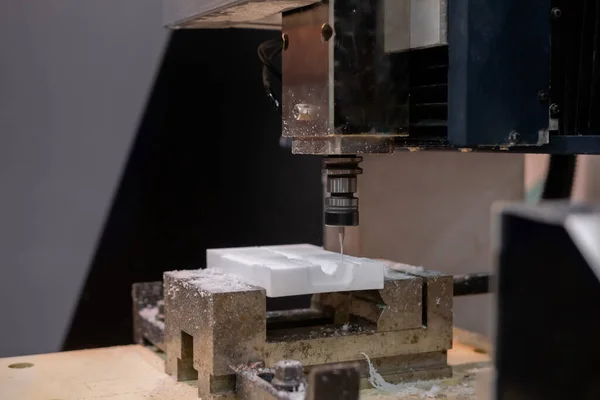 Turning milling machine cutting acrylic artificial stone workpiece - close up