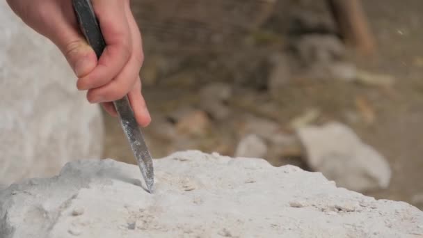 Man hand carving and shaping stone statue with chisel tool - slow motion — Stock Video