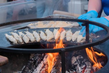 Aşçı yemek festivalinde siyah üzerine un kokulu Avrupa balığı pişirdi
